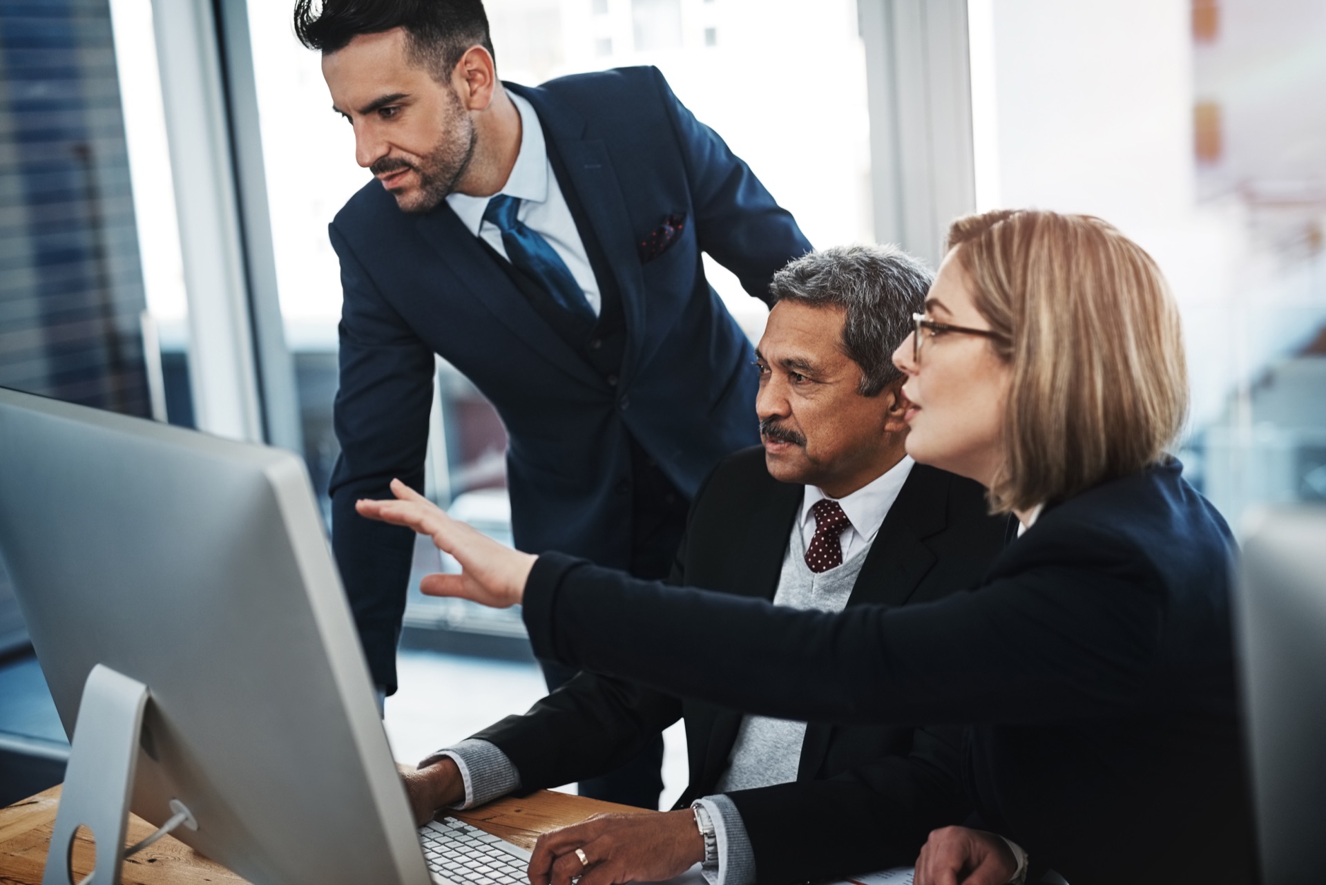 Business leaders reviewing information together on a computer